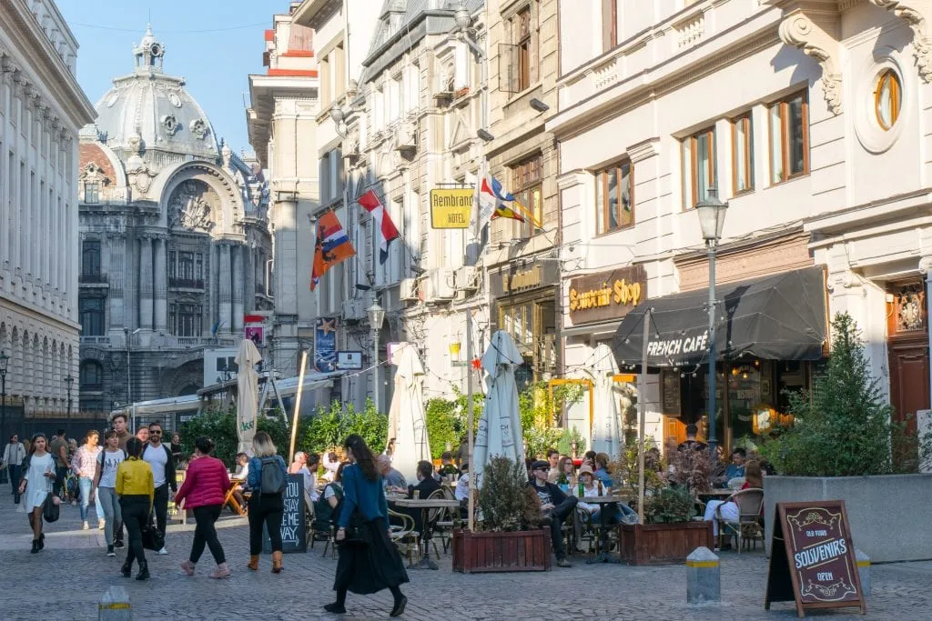 street scene in bucharest old town with ornate building in the background