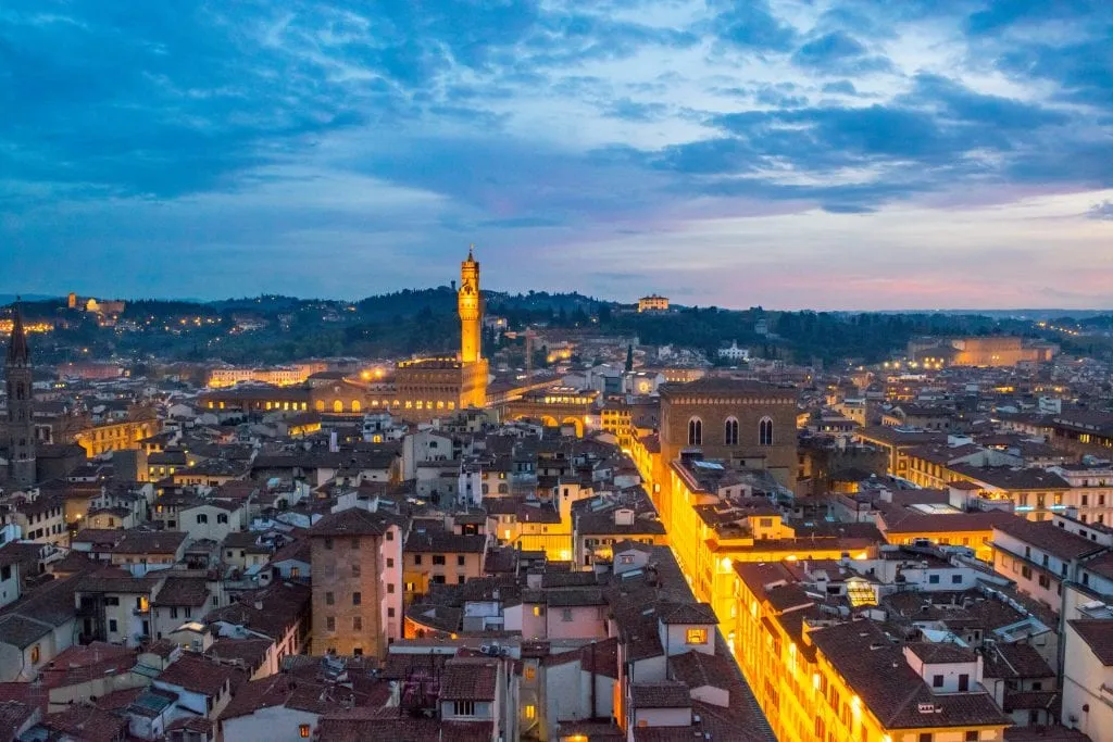 Florence Italy skyline at blue hour with Piazza Signoria lit up in the distance, an unforgettable addition to a Florence itinerary