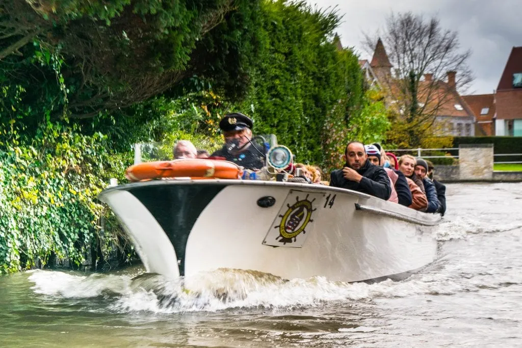 canal cruise in bruges belgium underway on a cloudy day, one of the best things to do in belgium in a few days 