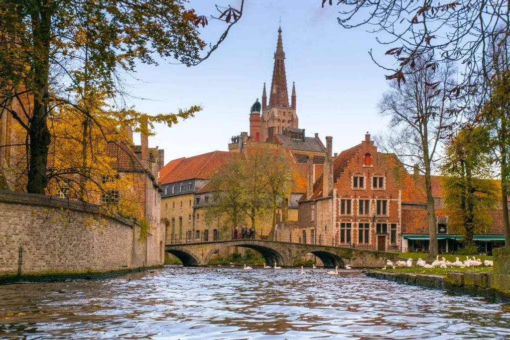 Bruges canal with boats in the background--don't miss your chance to take a canal cruise during your 3 days in Belgium itinerary