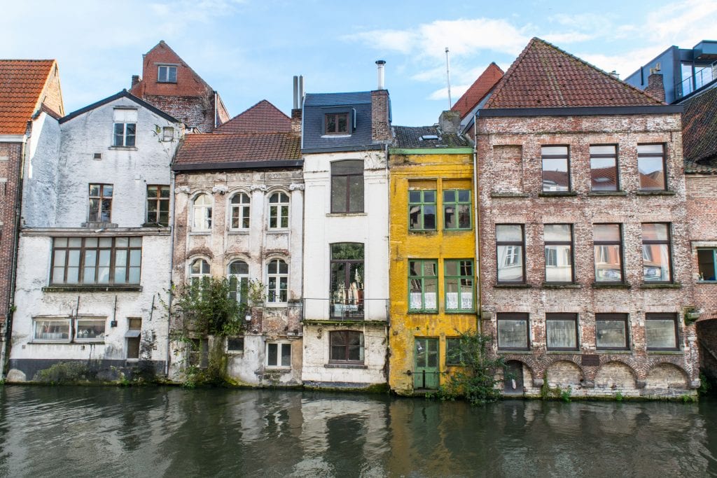 canal lined with narrow buildings in ghent
