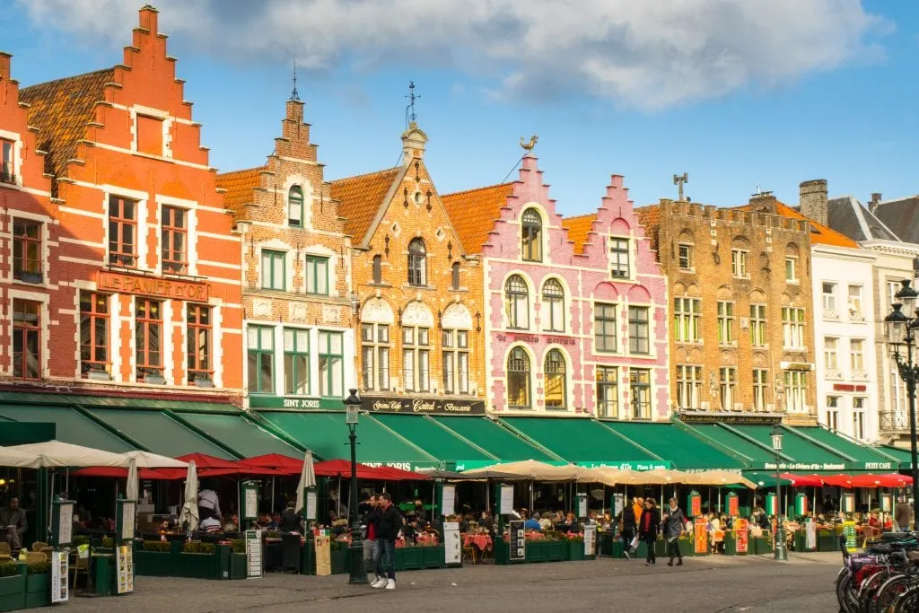 colorful building on the main square in bruges, a popular reason to visit bruges vs ghent
