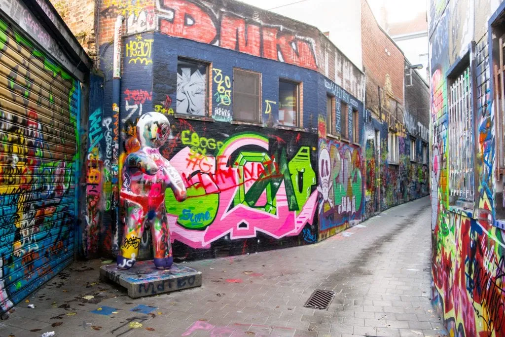 colorful street art in a narrow alley, one of the best places to visit in ghent belgium