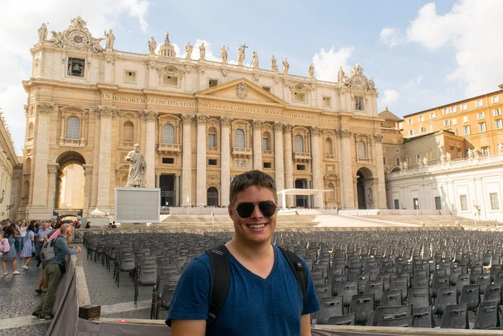 vatican tour today Jeremy Storm wearing aviator sunglasses standing in front of St Peter's Basilica when visiting Vatican City Rome