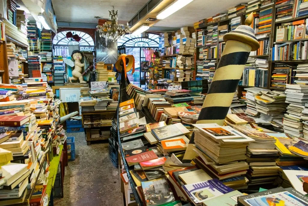 Libreria Acqua Alta in Venice with gondola of full of books to the right