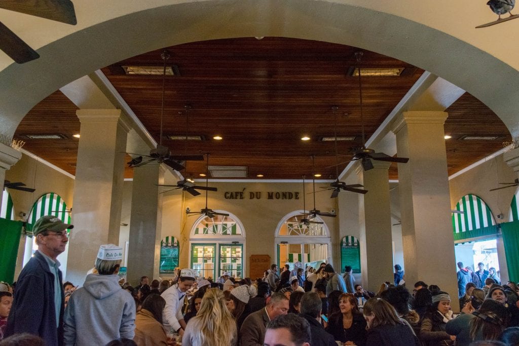 Porch of Cafe du Monde with a crowd visible toward the bottom. Don't miss Cafe du Monde during your 3 days in New Orleans!
