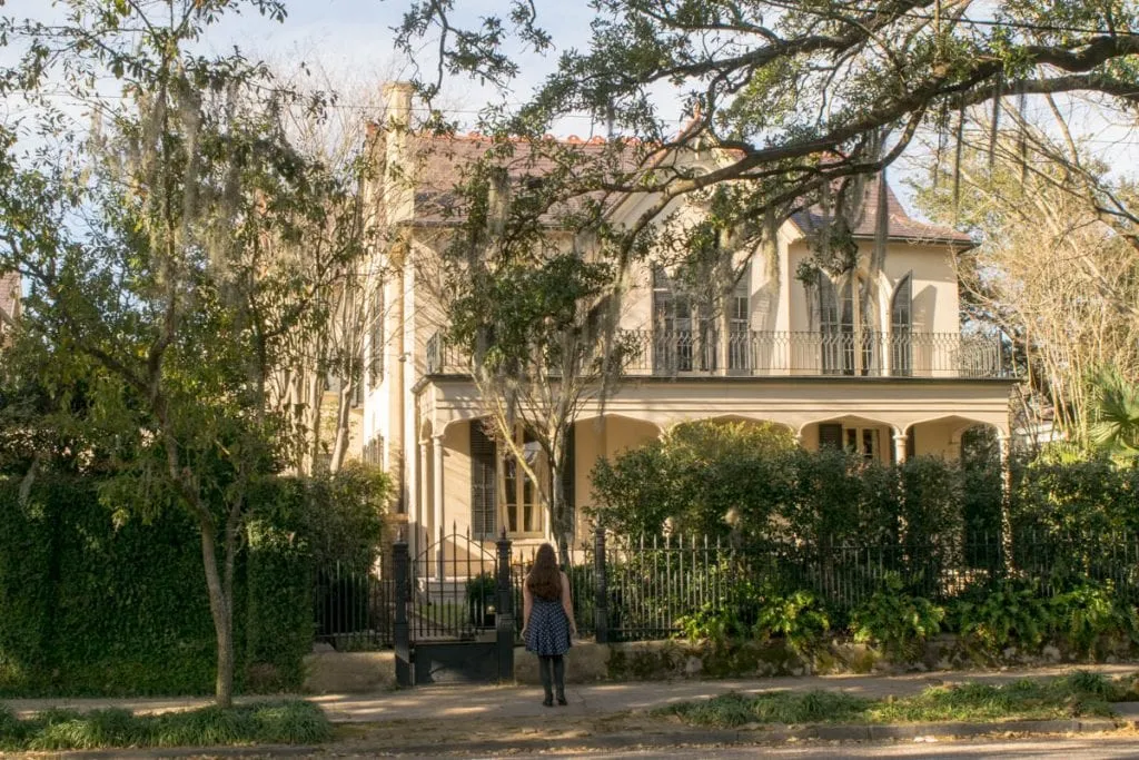 kate storm standing in front of a nola garden district mansion during a romantic 3 days in new orleans la