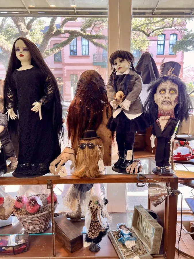 halloween masks and dolls for sale in an oddities store on magazine street in new orleans