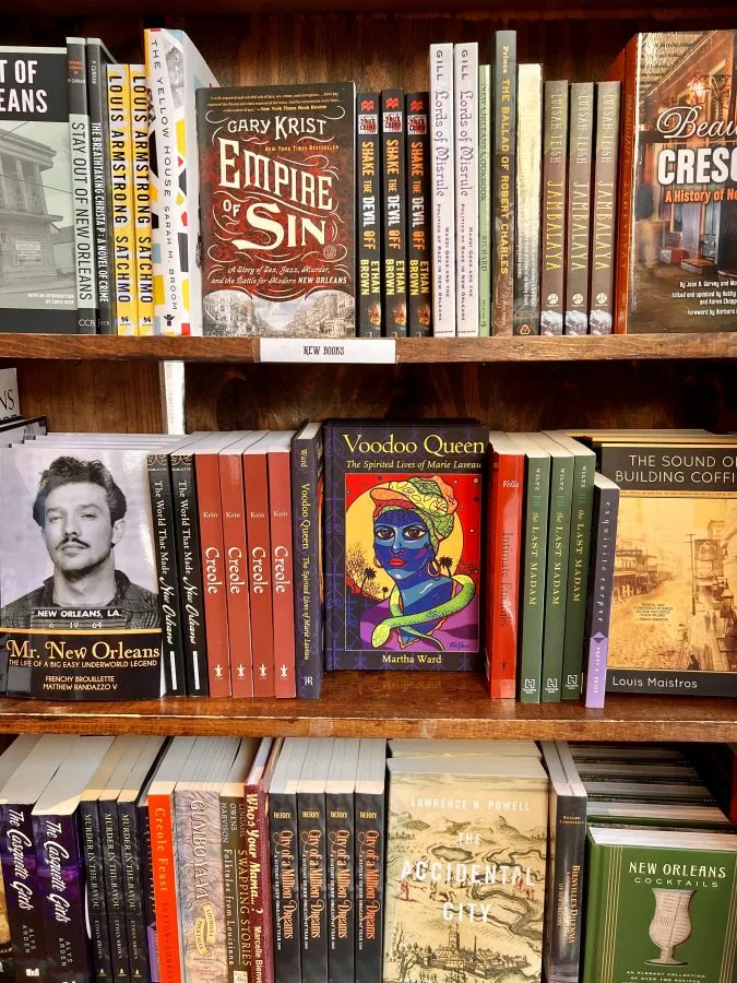 collection of books about new orleans on the shelf in a shop