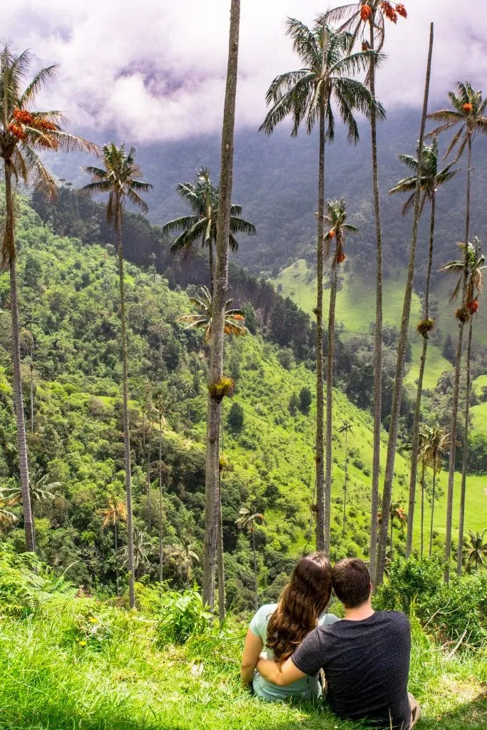 kate storm and jeremy storm sitting in the cocora valley salento colombia
