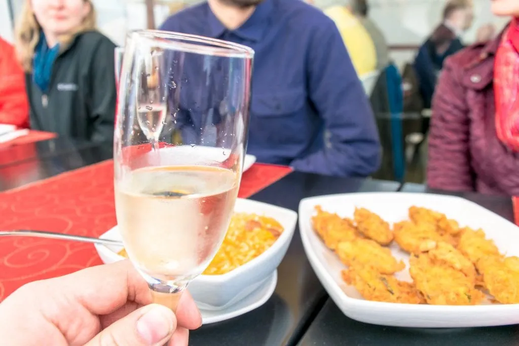 fried fish and wine enjoyed on taste of lisboa food tour campo de ourique