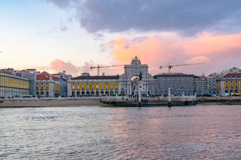 view of praca do comercio from the water at sunset in lisbon in 4 days