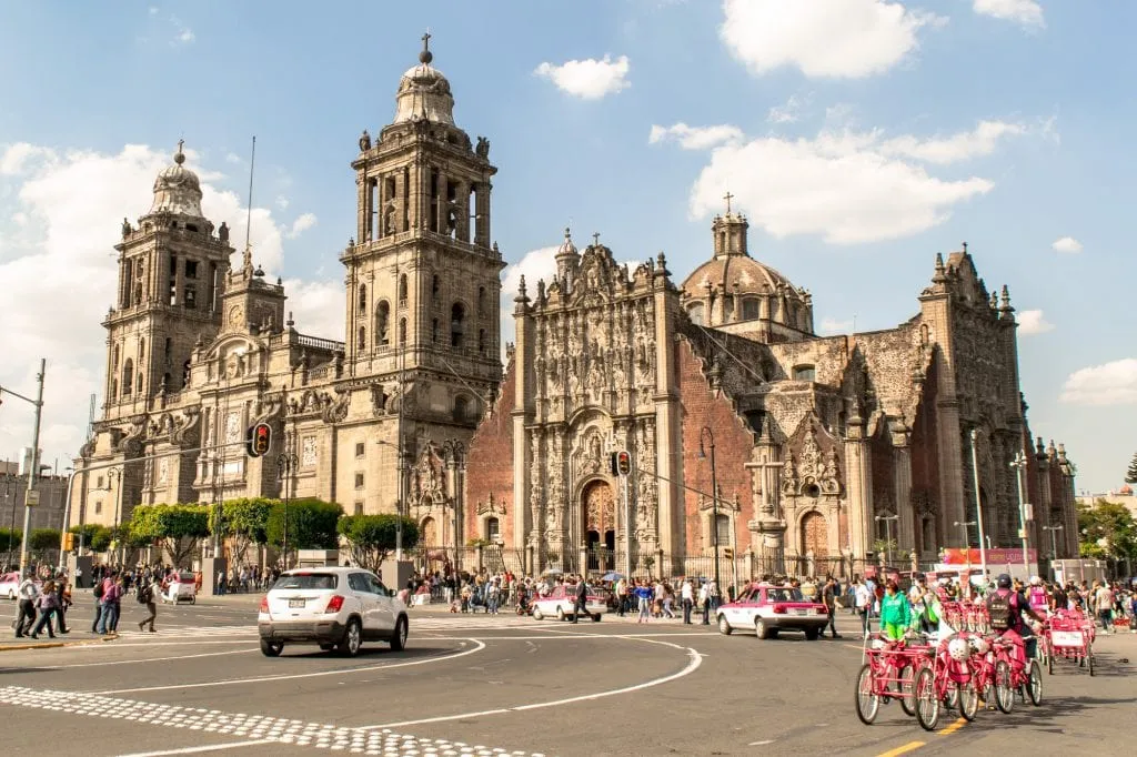 exterior view of mexico city metropolitan cathedral with traffic in the foreground