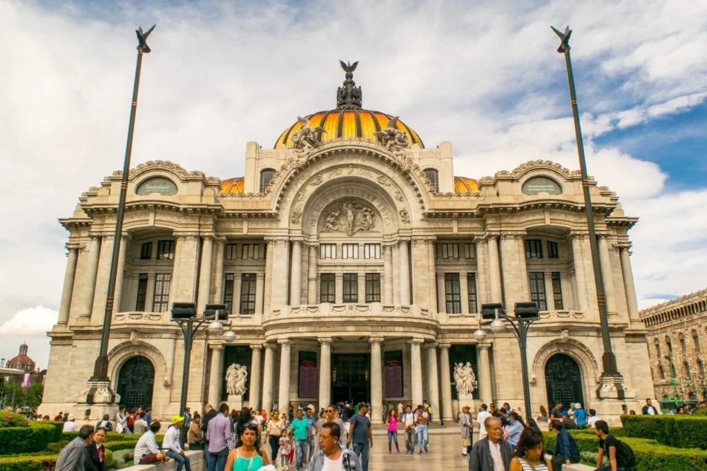 front facade of palacio de bellas artes in mexico city with people in the foreground