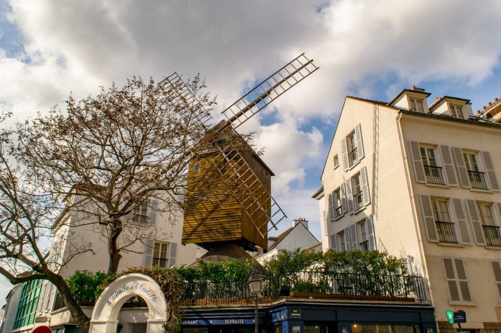 windmill on top of restaurant montmartre, one of the last remaining windmills in paris