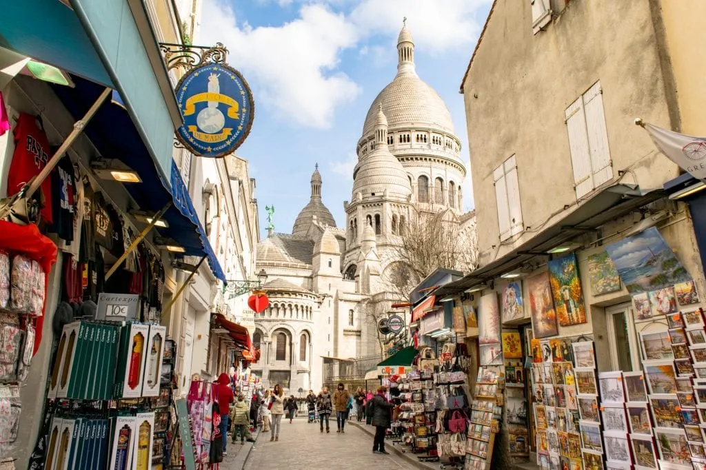 view of sacre coeur from montmartre paris shopping street during a few days in paris france