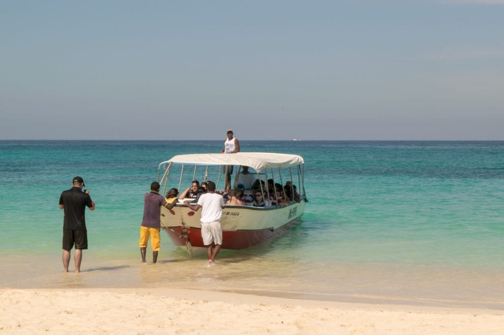 Boat of tourists arriving to the beach of Playa Blanca near Cartagena Colombia