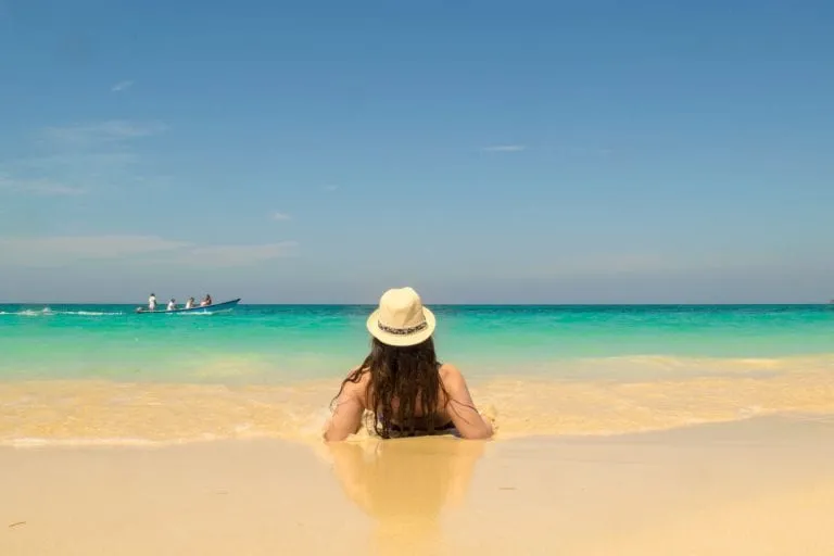 kate storm in a sunset laying on the edge of playa blance cartagena colombia beach