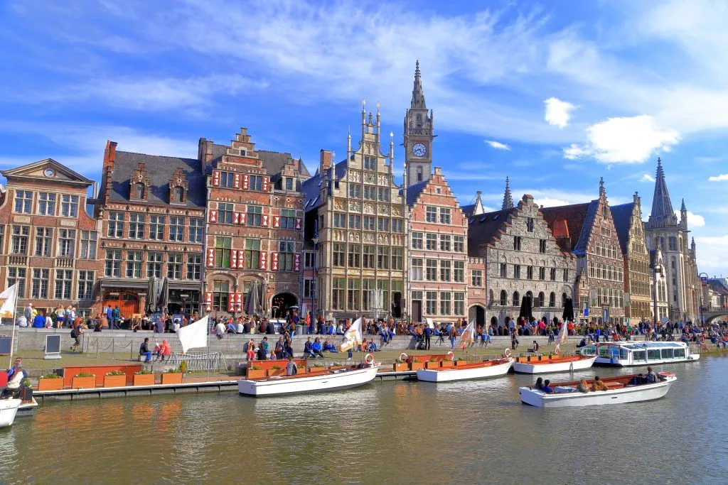 historic buildings in ghent belgium with canal cruises in the foreground