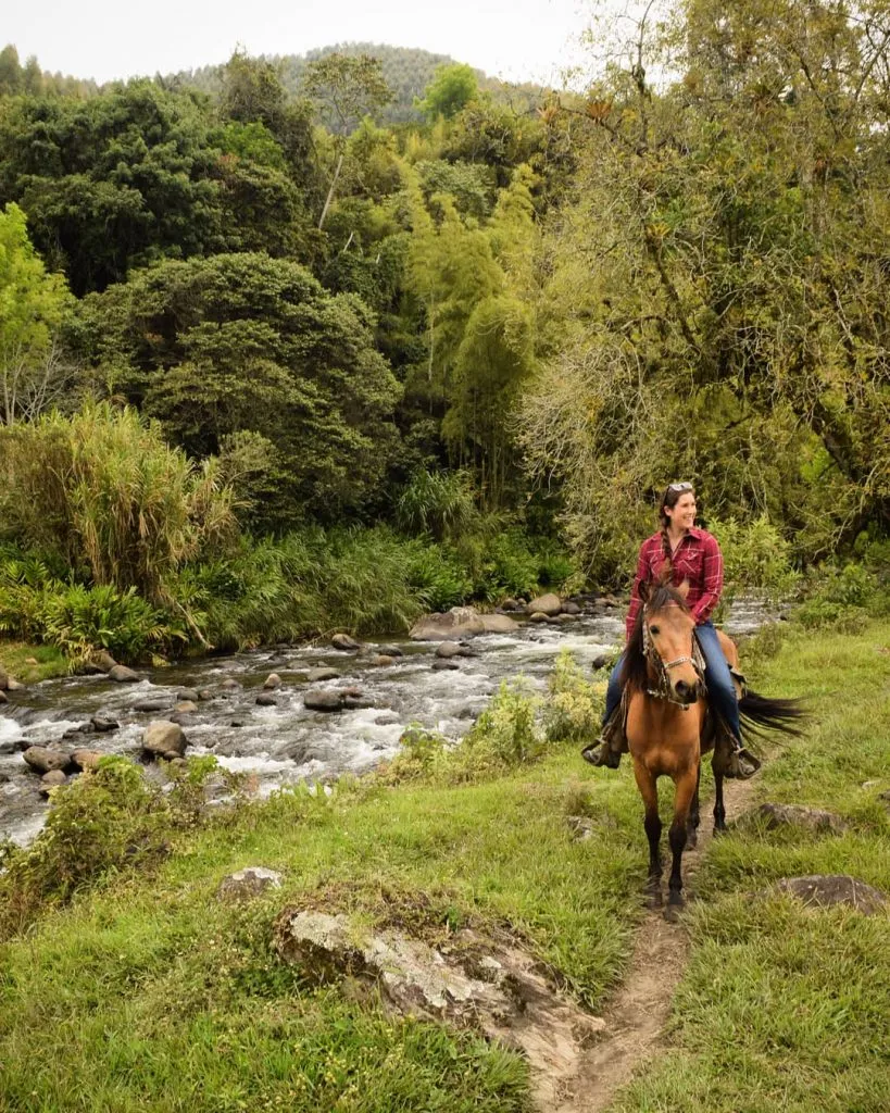 kate storm on horseback next to a stream, one of the best activities in salento colombia