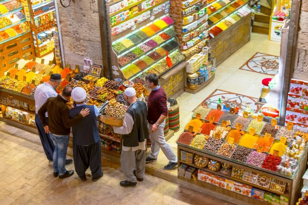 collection of men at a bazaar stand in the spice market istanbul