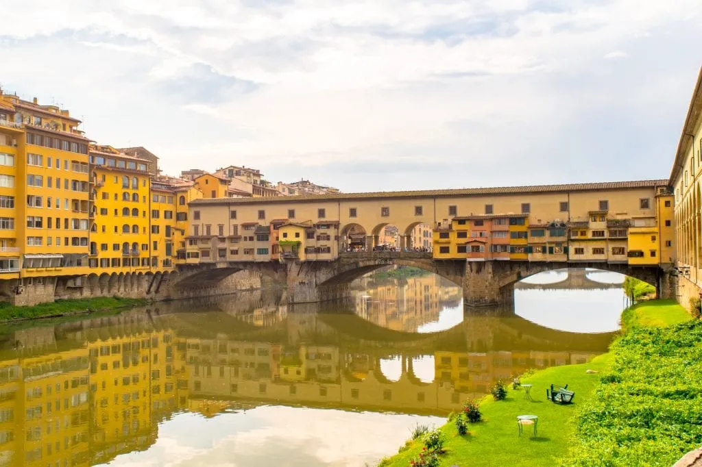 view of the ponte vecchio from banks of the arno river in florence italy