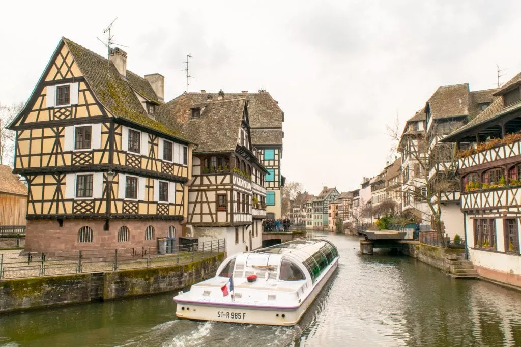 view of a panoramic boat tour making its way through the strasbourg canals, one of the best things to do with one day in strasbourg france