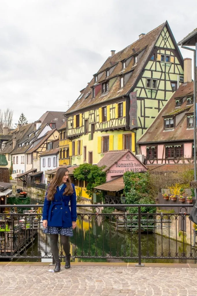 Kate Storm standing on a bridge in La Petite Venise, one of the best places to visit in Colmar France