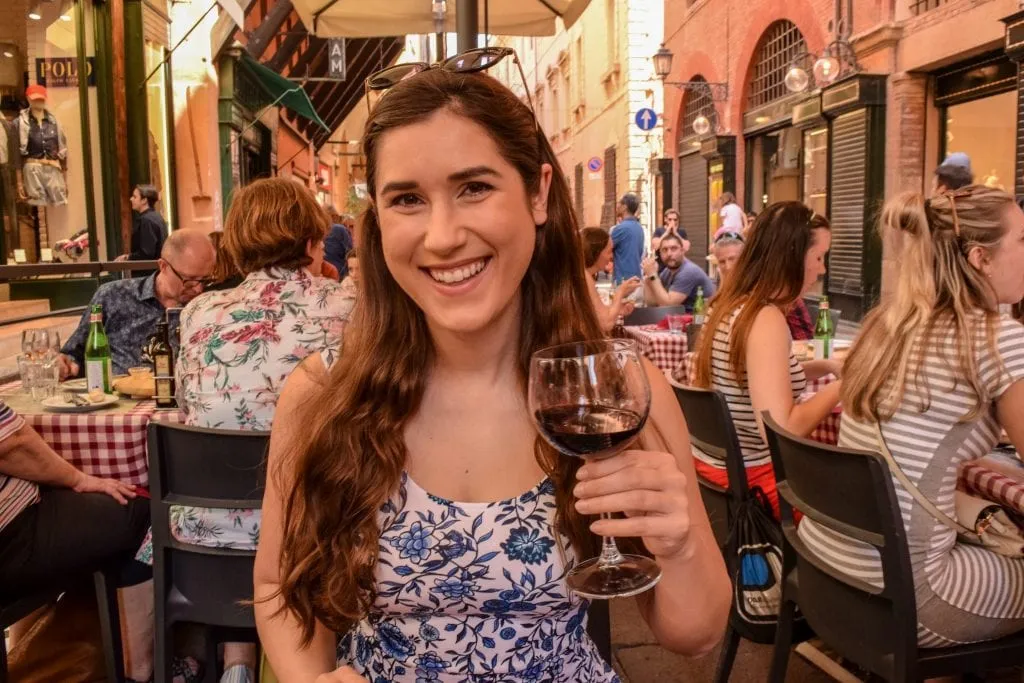 Woman drinking wine at restaurant in Bologna, Florence to Bologna Train