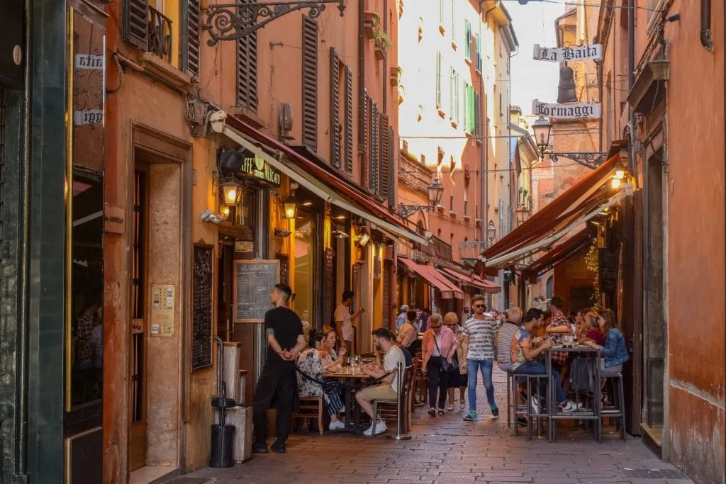 Crowded street in Bologna with outdoor restaurant, Florence to Bologna Train