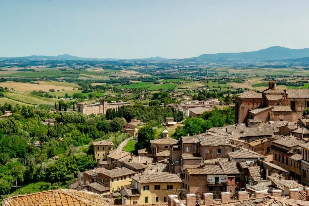 rooftops of siena italy with the countryside beyond. siena belongs on any tuscany bucket list