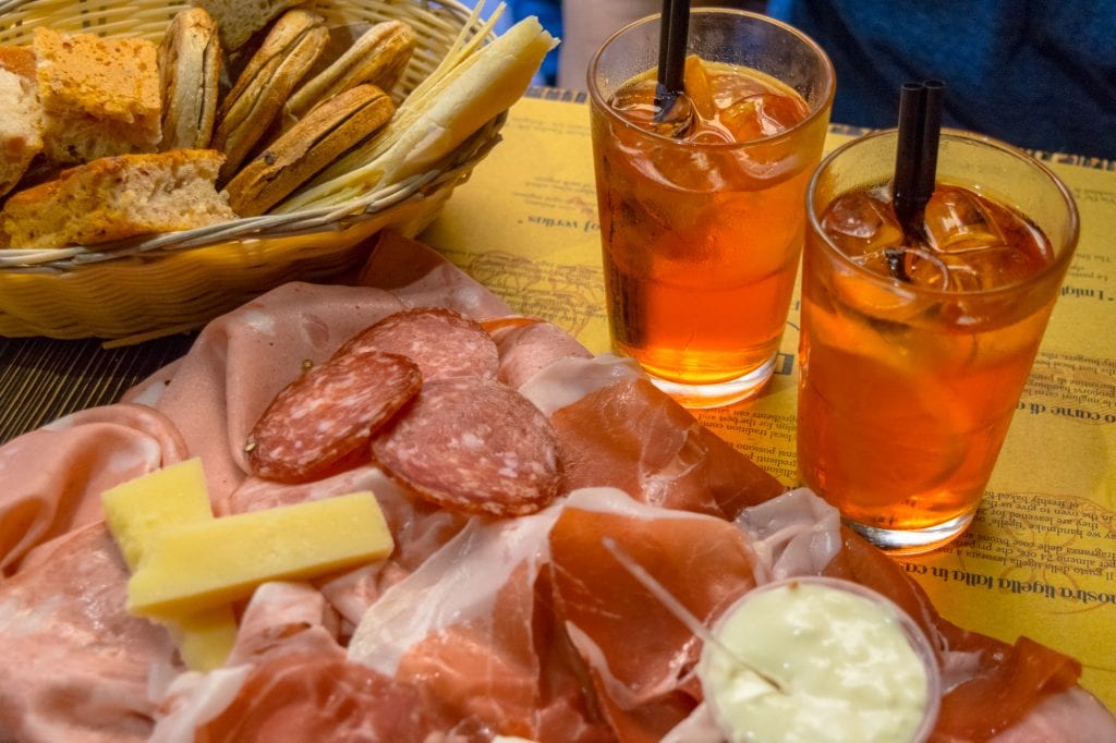 plate of cured meat and aperol spritzes, and excellent addition to a one day in bologna itinerary