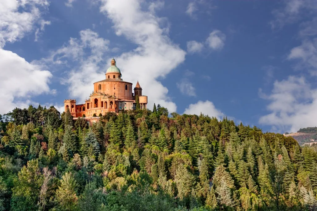 Sanctuary of the Madonna di San Luca at the top of a tree colored hill near bologna italy