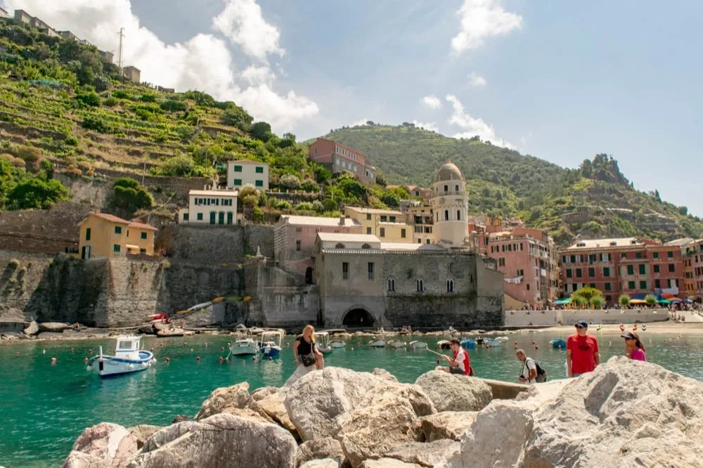 swimmers enjoying vernazza harbor in cinque terre tips