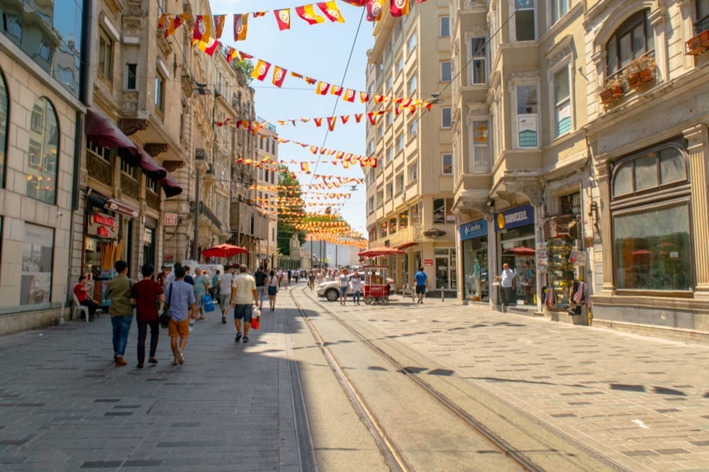 view of istanbul istiklal street with red and yellow flags hanging over it