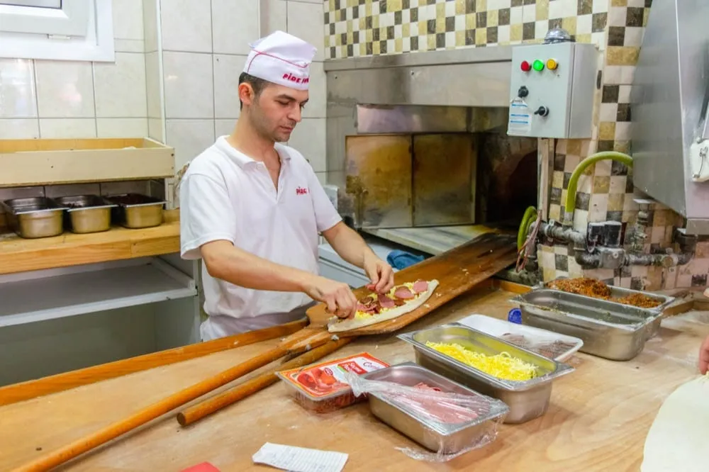 man in istanbul cooking pide