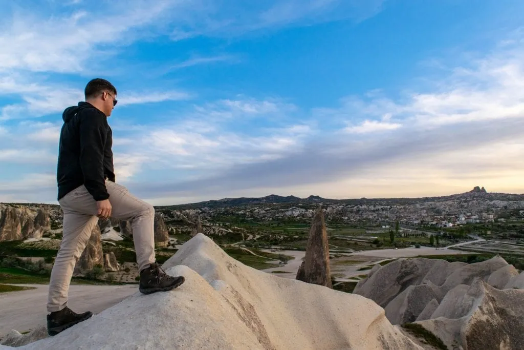 jeremy storm standing on a rock ledge in cappadocia turkey