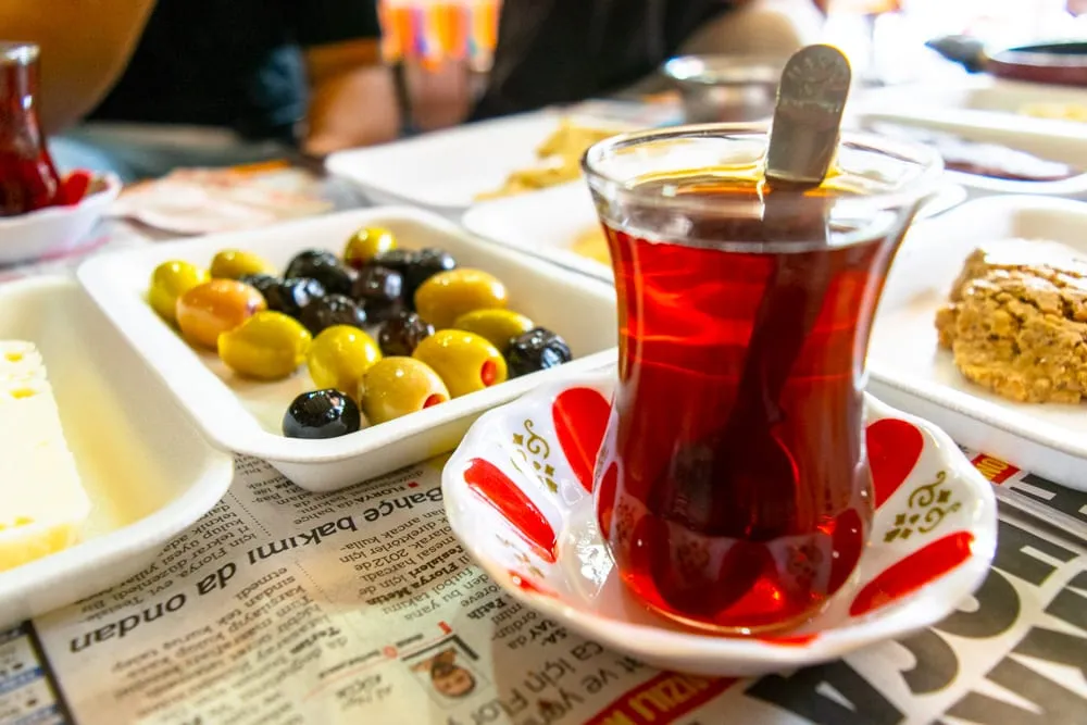 turkish tea cup with a plate of olives next to it, one of the best istanbul attractions