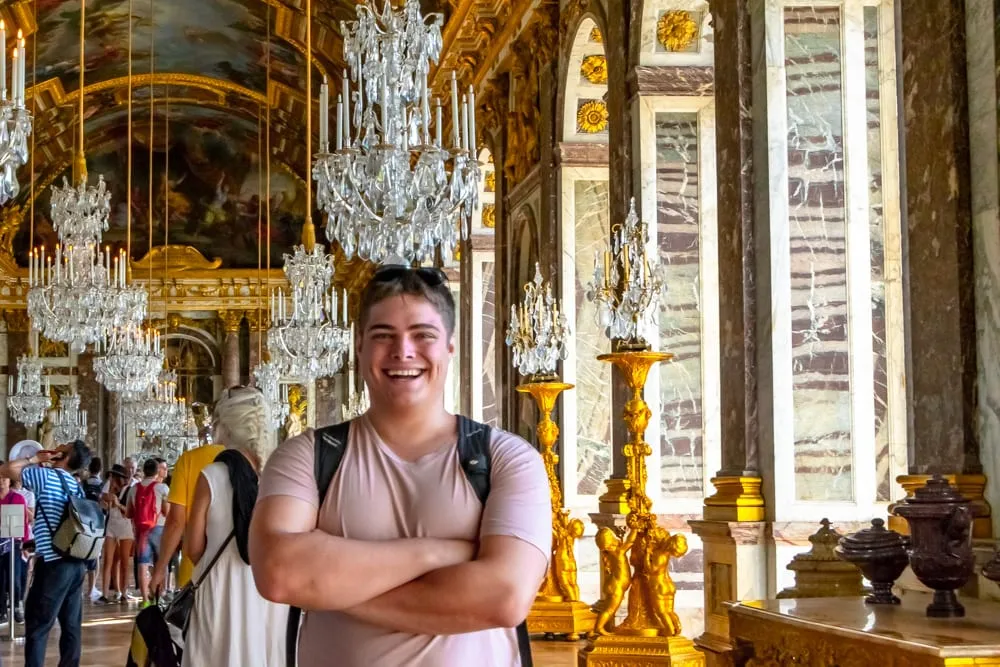 jeremy storm standing in the hall of mirrors in versailles palace