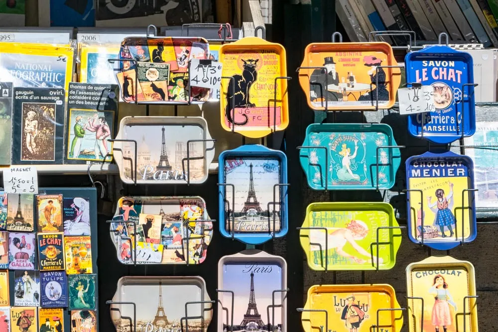 collection of trays for sale as paris souvenirs, some with le chat nori theme