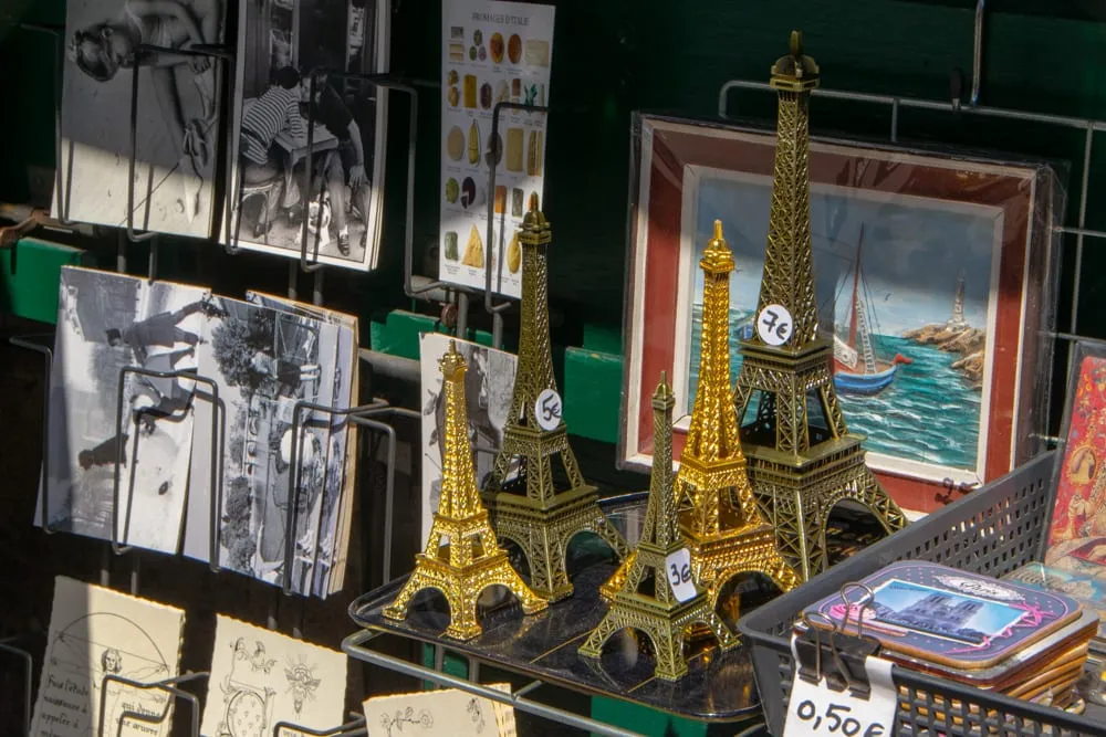 souvenir eiffel towers for sale at a bouquinista one day in paris france