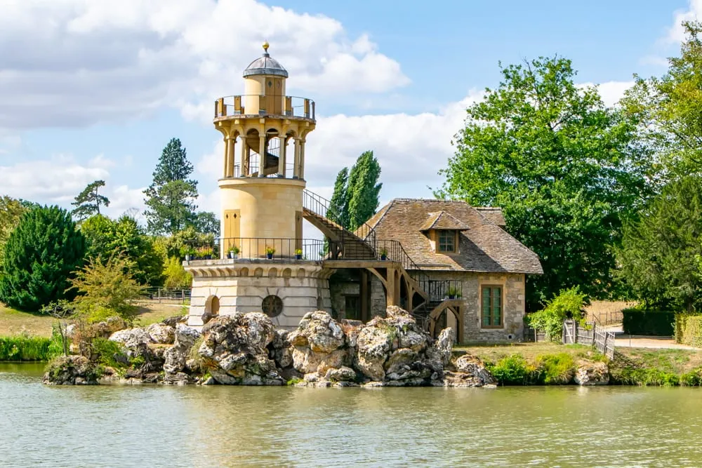 tower at marie antoinette hamlet as seen from across the water on a visit versailles