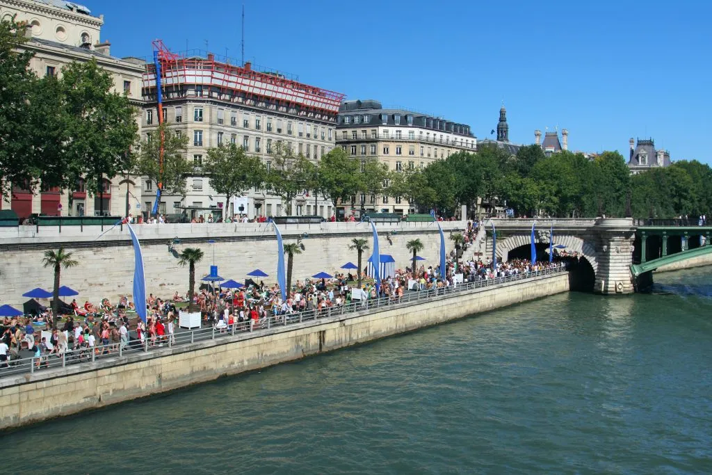 paris plages along the seine in august as seen from across the river