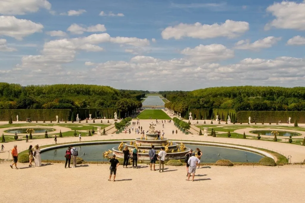 view of the versailles gardens from just outside the palace on a versailles day trip from paris