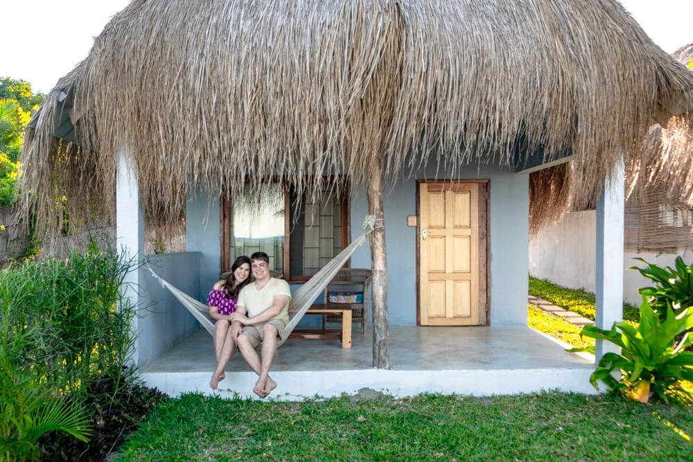kate storm and jeremy storm in a hammock in front of a small villa in vilanculos mozambique