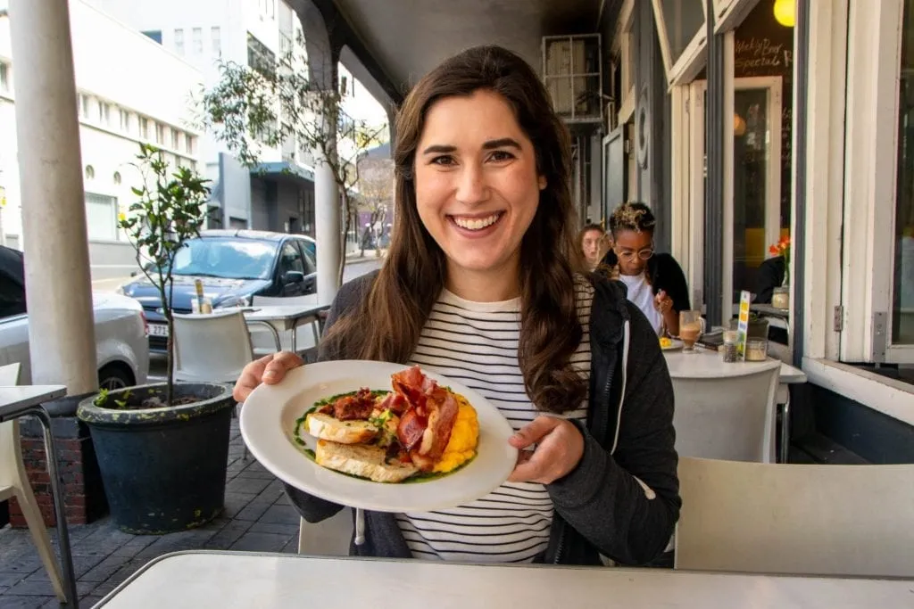 kate storm holding up a breakfast in cape town south africa itinerary