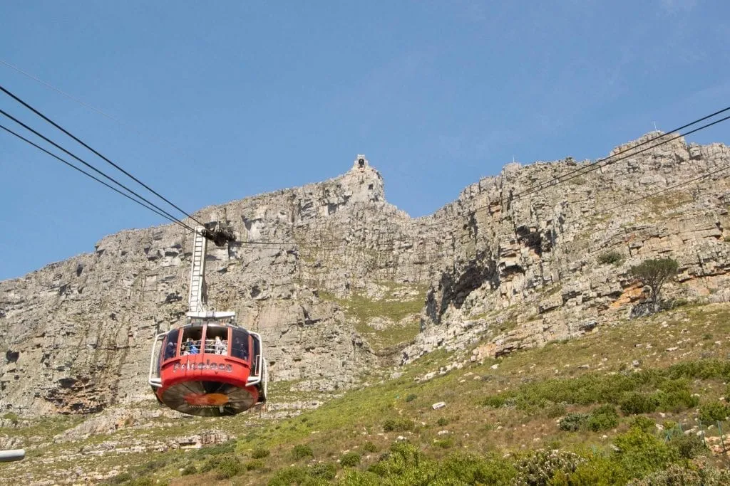 red cable car climbing table mountain during an itinerary for cape town south africa