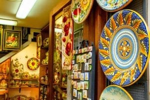 ceramic plates at the entrance to a travel souvenir shop in orvieto italy, one of the best things to collect while traveling