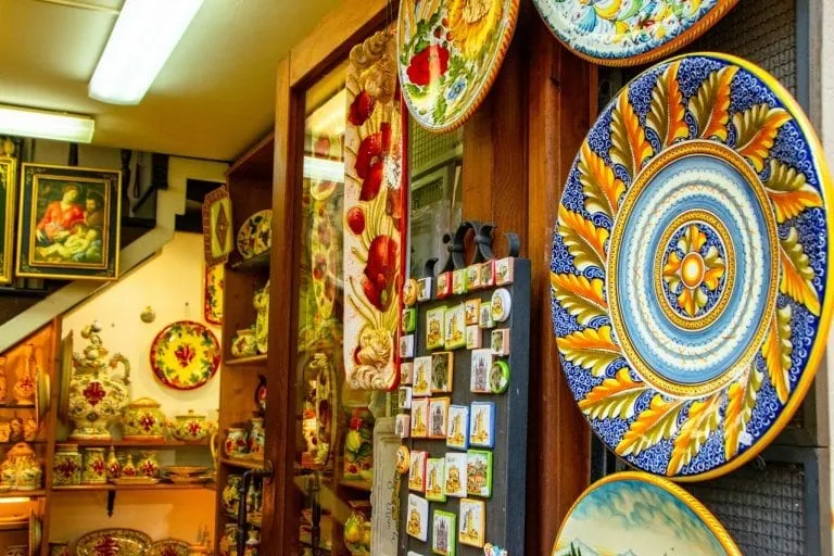 ceramic plates at the entrance to a travel souvenir shop in orvieto italy, one of the best things to collect while traveling