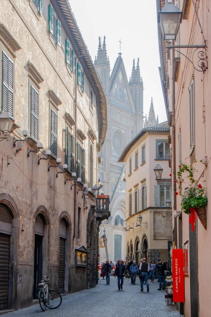 picturesque street in orvieto with duomo at the end, belongs on any list of what to do in orvieto italy